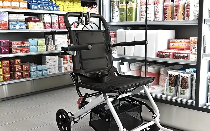 Folded scooter next to suitcase